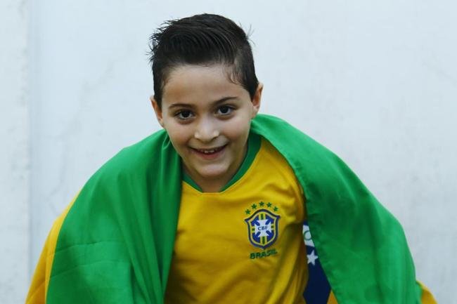 Os jogos da Copa do Mundo concentram em si os olhares de todos os pa�ses do mundo e criam um ambiente de di�logo entre as mais espa�adas gera��es. Dona Wanda, com 85 anos. Bruno Vin�cius, com 29 anos, e Arthur Mour�o, com sete anos.