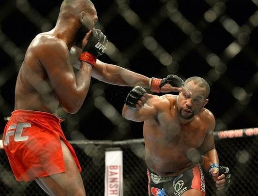 Jon Jones (bermuda vermelha) venceu Daniel Cormier por decisão unânime e manteve o cinturão