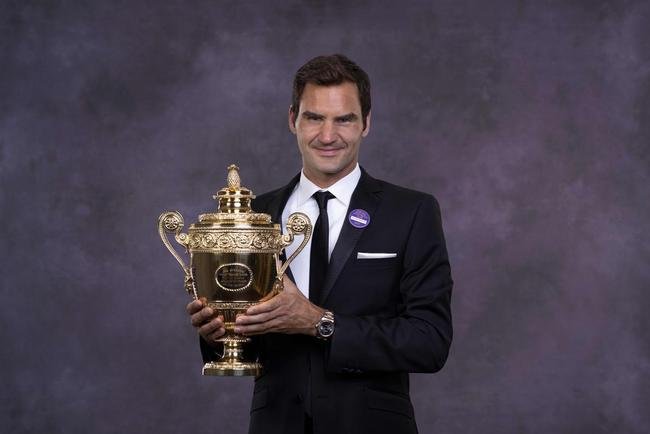 Roger Federer posa com o trofu de Wimbledon de 2017 em jantar de gala, em Londres