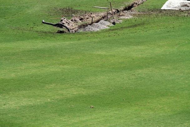 Funcionários do clube trabalham para recuperar o gramado após as fortes chuvas que caíram no Recife